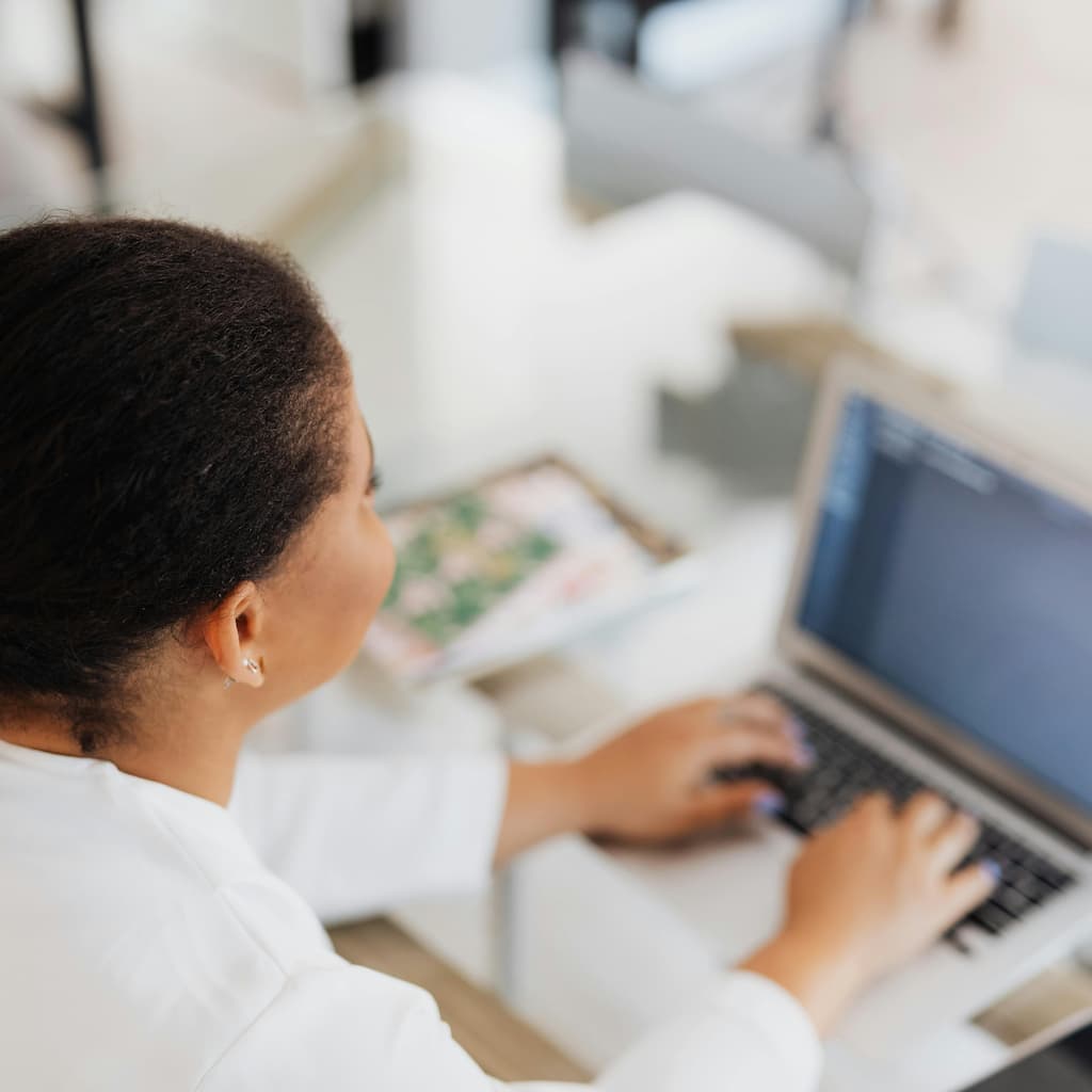 Doctor working on a laptop at a desk