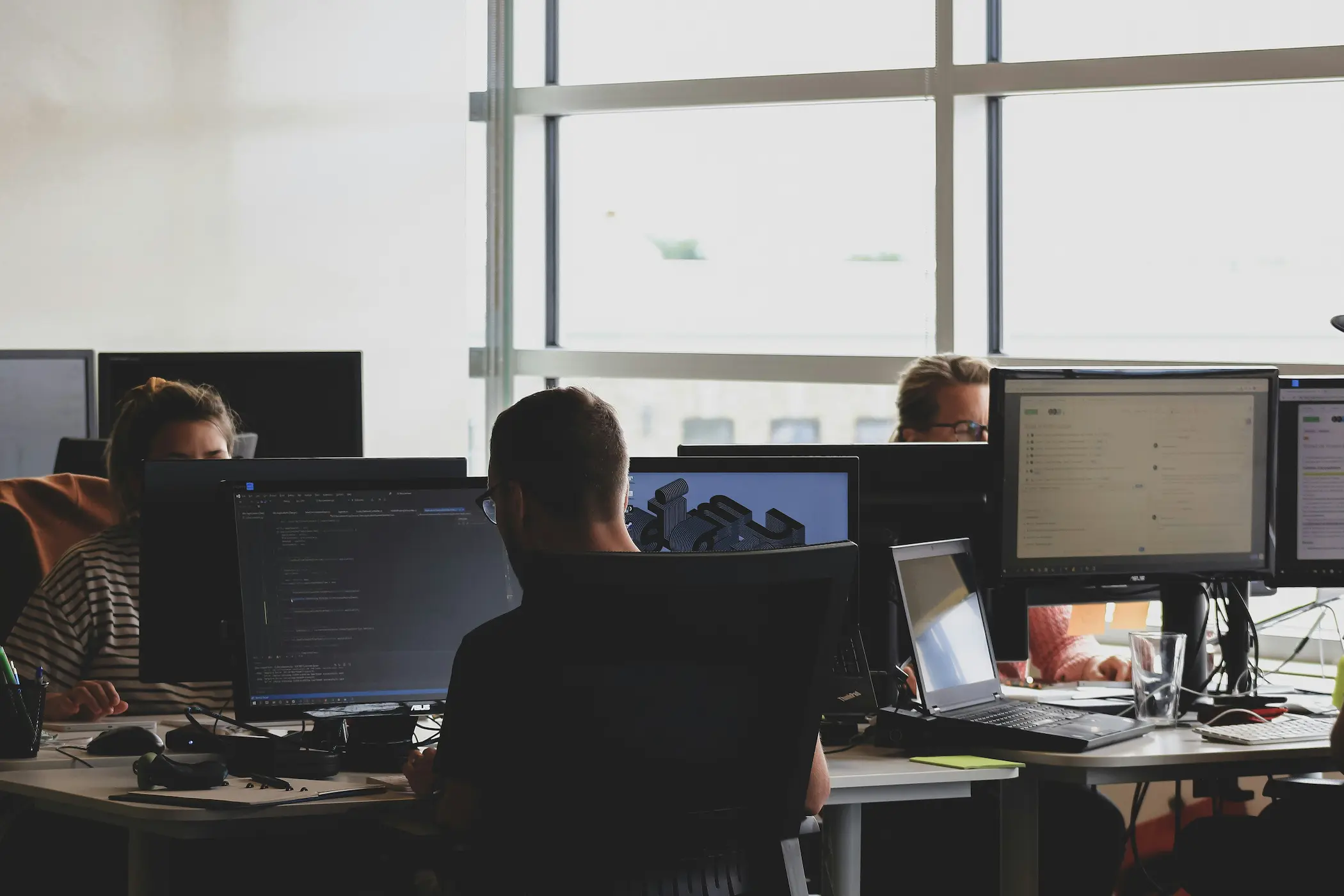 Web developer writing code on a laptop
