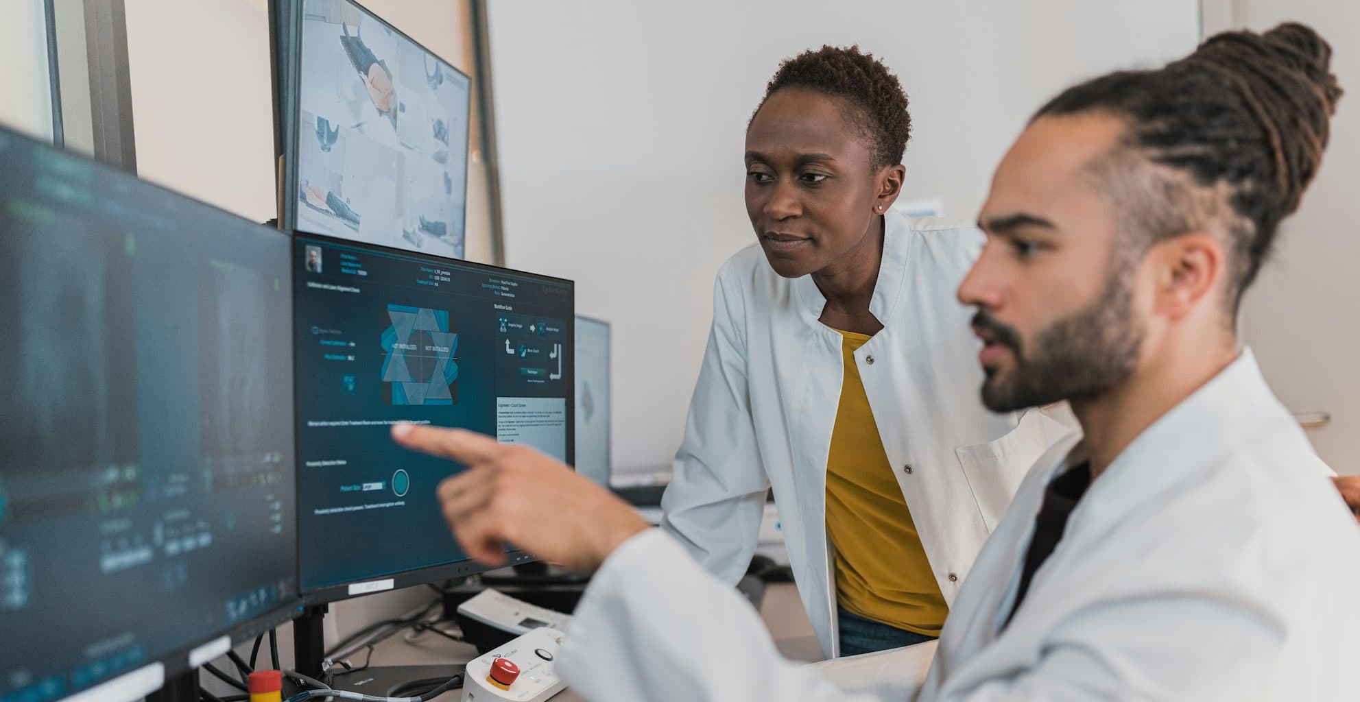 Doctors reviewing diagnostic images on computer monitors