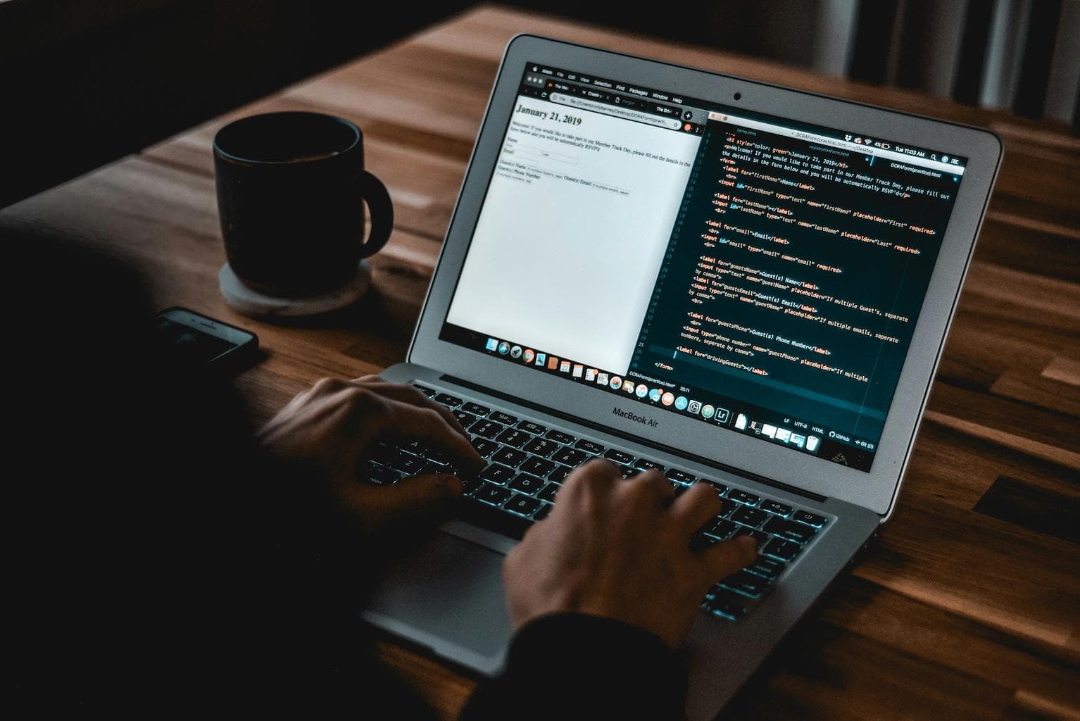Web developer writing code on a laptop